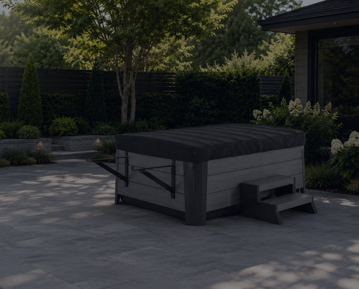 Rollaway cover closed on a hot tub in a landscaped backyard