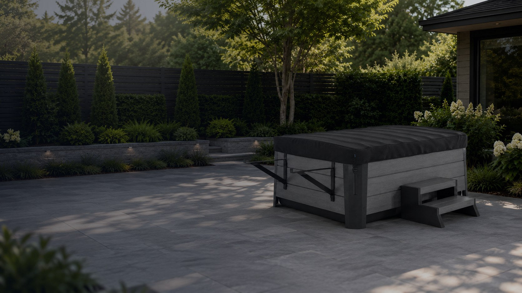 Rollaway cover closed on a hot tub in a landscaped backyard